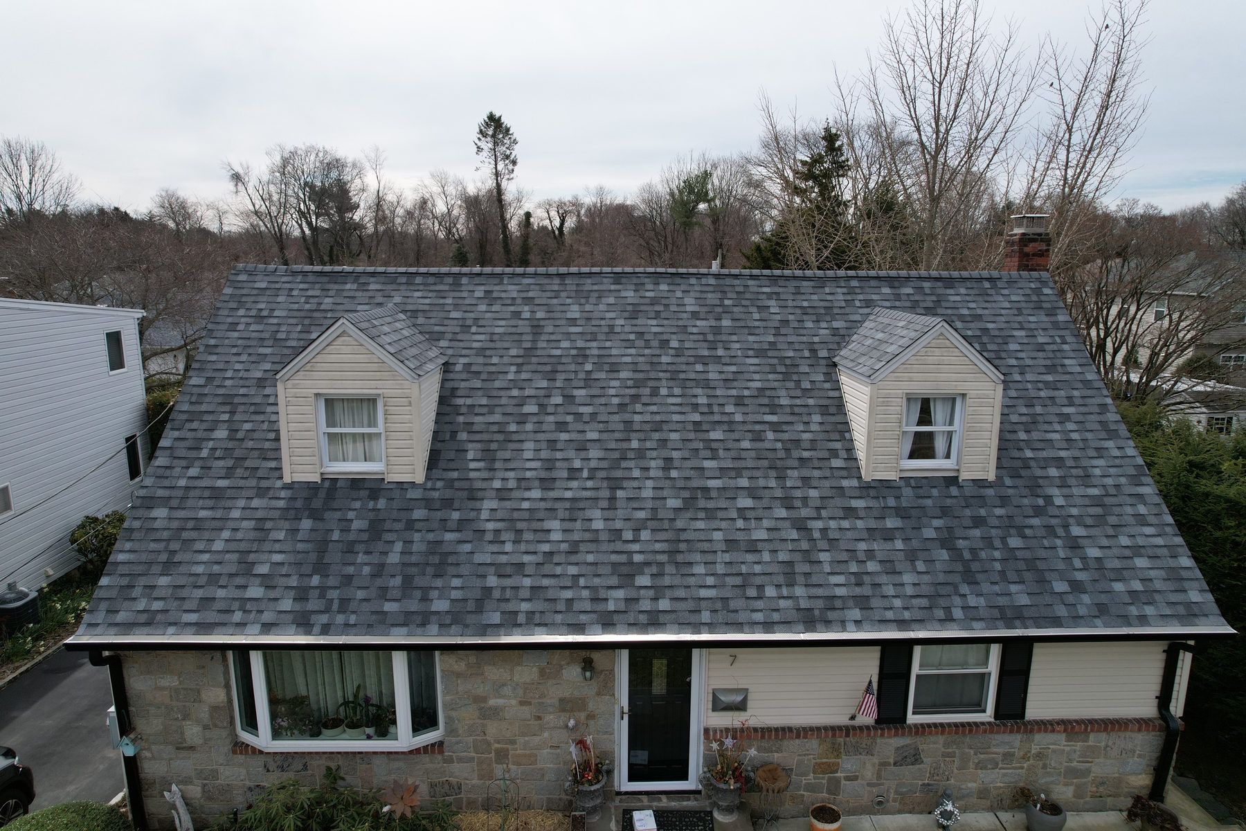Cape-style home with a new charcoal shingle roof and two dormers