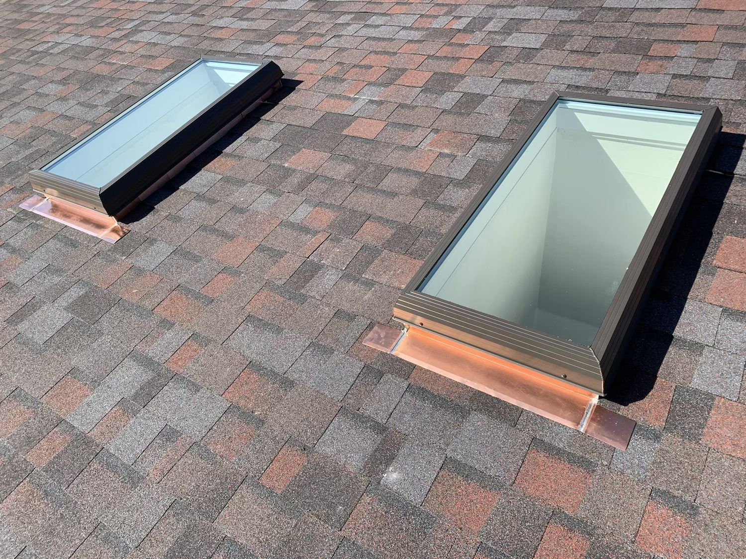 Two new skylights set into a shingle roof
