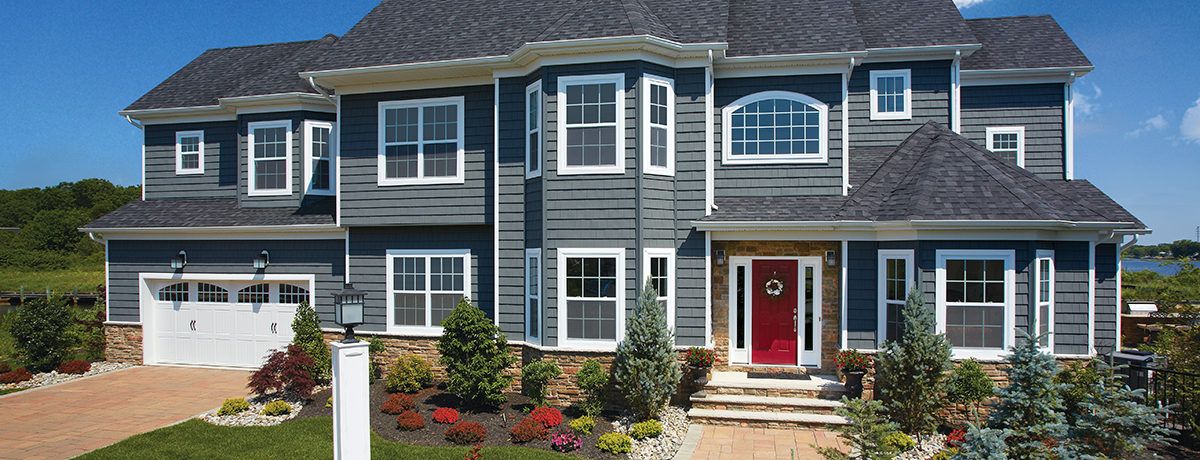 Blue-gray siding on a two-story home with white trim